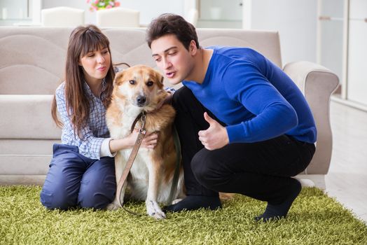 Happy family with golden retriever dog