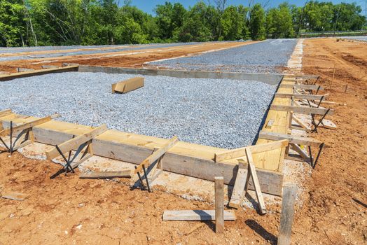 Horizontal shot of the initial ground work for pouring concrete slabs at a new construction site.