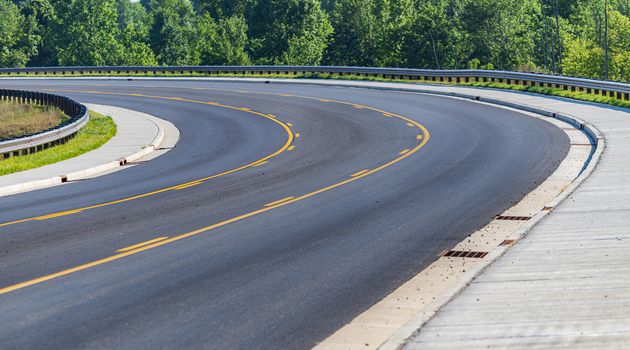 Horizontal shot of the curve in a new city street.