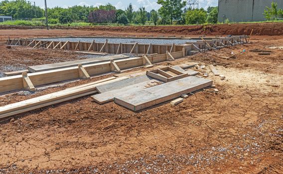 Horizontal shot of boards assembled at a construction site for pouring a concrete slab.