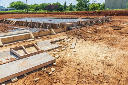 Horizontal shot of a construction site with an area prepared for the pouring of a concrete slab for a new commercial building.