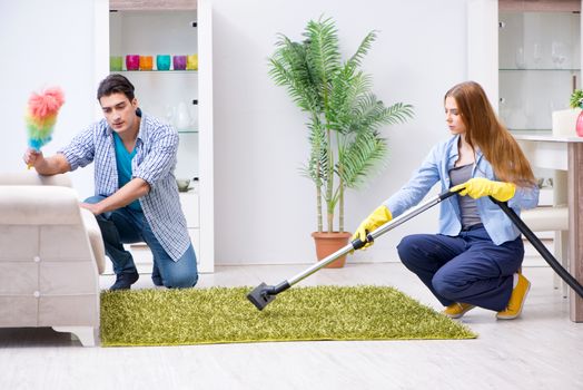 Young family cleaning the house