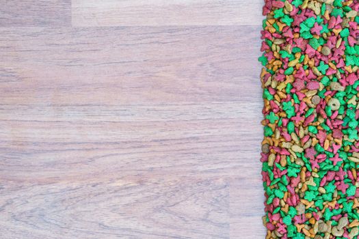 Top view dry cat food on wooden background with copy space