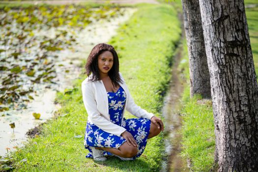 Cheerful young woman standing at outdoor with flower.