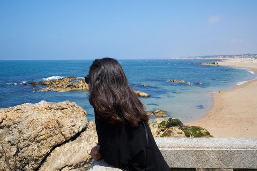 Woman in Praia do Senhor da Pedra beach, in Miramar Arcozelo, Portugal