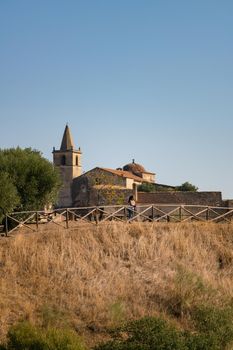 Caucasian woman looking at Juromenha castle on a summer day in Alentejo, Portugal