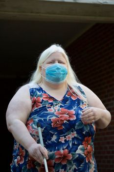 Close up of an albino woman wearing a medical mask and walking