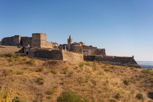 Juromenha castle and Guadiana river and border with Spain on the side of the river at sunrise, in Portugal