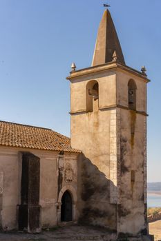 Juromenha castle tower and Guadiana river and border with Spain on the side of the river at sunrise, in Portugal