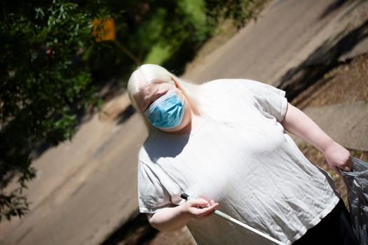 Close up of an albino woman wearing a medical mask