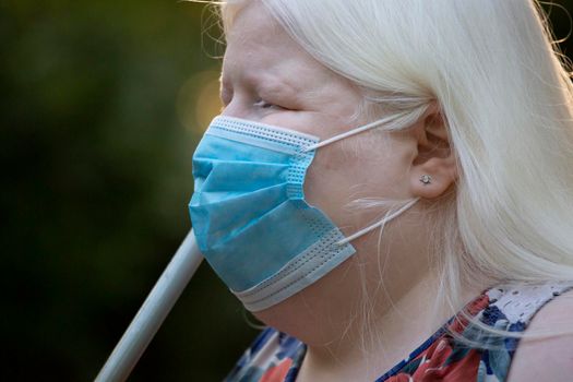 Close up of an albino woman wearing a medical mask