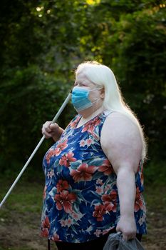 Close up of an albino woman walking and wearing a medical mask