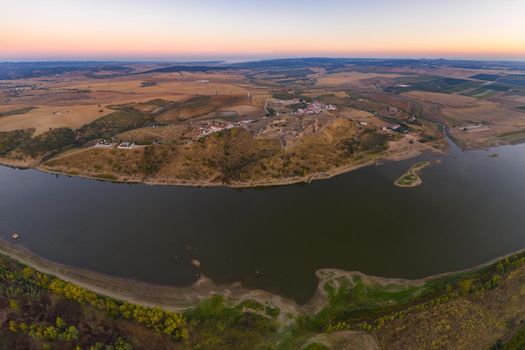 Juromenha castle, village and Guadiana river drone aerial view at sunset in Alentejo, Portugal and Spain on the foreground