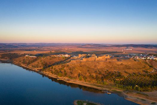 Juromenha castle, village and Guadiana river drone aerial view at sunrise in Alentejo, Portugal