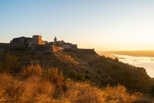 Juromenha castle and Guadiana river and border with Spain on the side of the river at sunrise, in Portugal