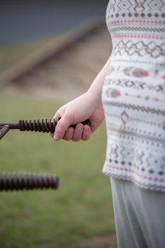 Woman turning the crank on an outdoor grill