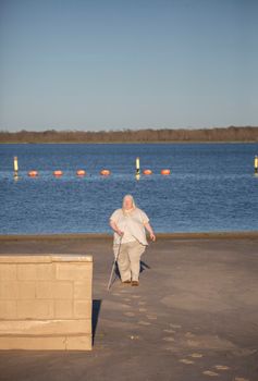 Blind woman walking away from a swimming area
