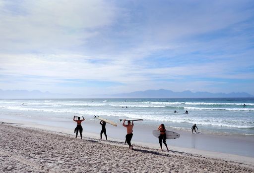 MUIZENBERG BEACH, CAPE TOWN, SOUTH AFRICA - 9 March 2018 : MUIZENBERG BEACH, CAPE TOWN, SOUTH AFRICA - 9 March 2018 : Muizenberg beach is a common morning surf spot for Capetonians.