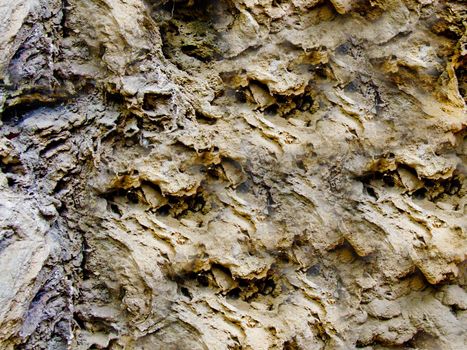 Rough and rough texture of the stone with depressions on the surface.Texture or background