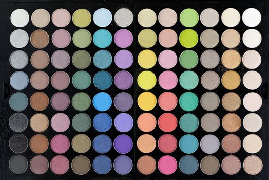 Multi-colored large professional set for face and eye makeup close-up.Texture or background