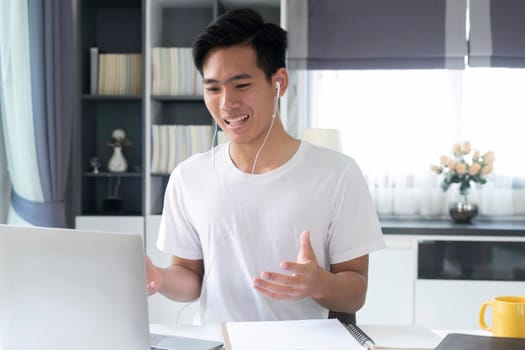 Young man working and learning online at home. Young man video call conference online with his colleagues.