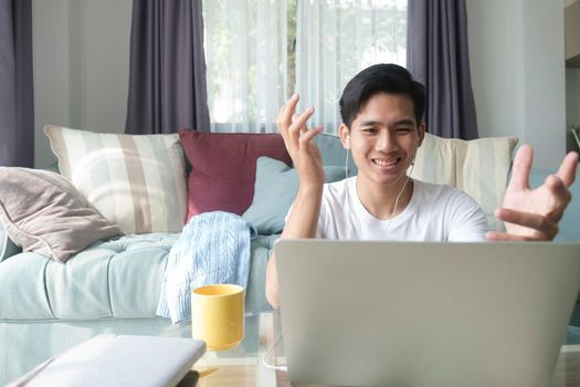 Young man working and learning online at home. Young man video call conference online with his colleagues.