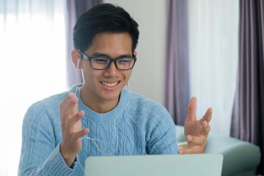 Young man working and learning online at home. Young man video call conference online with his colleagues.