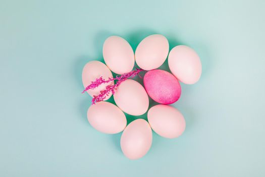 Easter. White eggs with a red egg and a twig on a uniform blue background. Place for text.