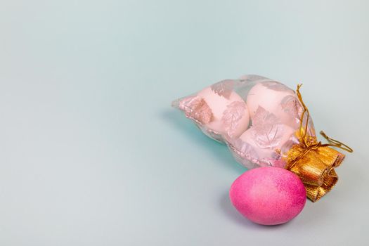 Easter. White eggs with a red egg in a bag on a uniform blue background. Place for text.