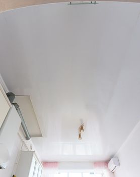 Ceiling made of white plastic panels in the interior of the kitchen