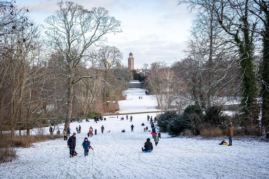 Copenhagen, Denmark - January 31, 2021: People enjoying a snowy winter day in Frederiksberg Gardens.