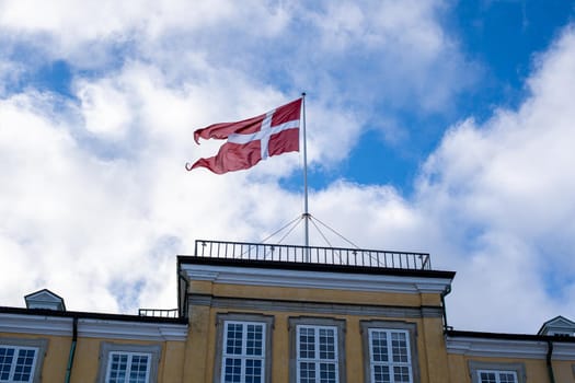 Frederiksberg, Denmark - January 31, 2021: Danish flag called DAnnebrog on top of Freeriksberg Palace.