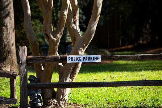 White and black police parking sign on a wooden fence