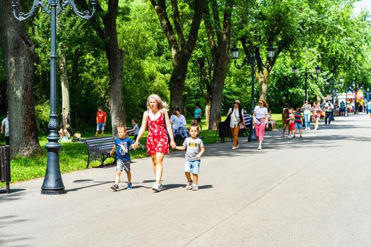 People walking, relaxing and have fun on the alleys of park and gardens of the domain from Mogosoaia in Bucharest, Romania, 2020.