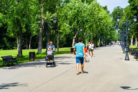 People walking, relaxing and have fun on the alleys of park and gardens of the domain from Mogosoaia in Bucharest, Romania, 2020.