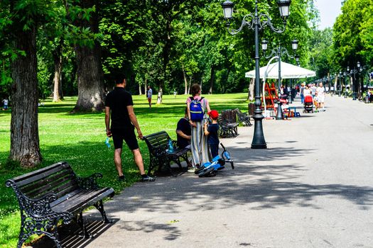 People walking, relaxing and have fun on the alleys of park and gardens of the domain from Mogosoaia in Bucharest, Romania, 2020.