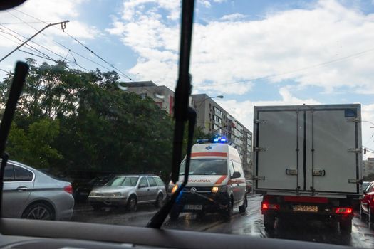 Traffic in cloudy rainy day with road view through car front window in Bucharest, Romania, 2020