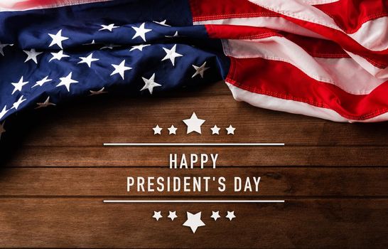 United States National Holidays. American or USA Flag with "HAPPY PRESIDENT'S DAY" text on wooden background, President Day concept