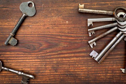 Old keys arranged on wood, flat lay