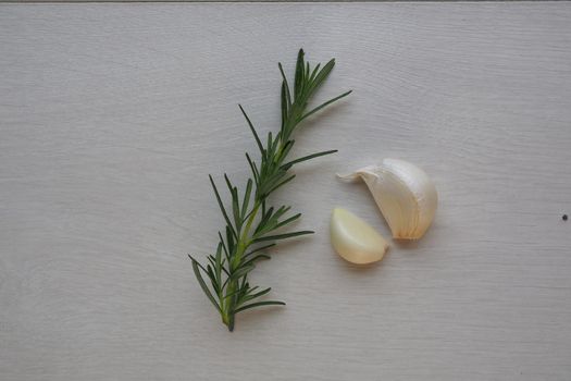 garlic clove and rosemary on white background