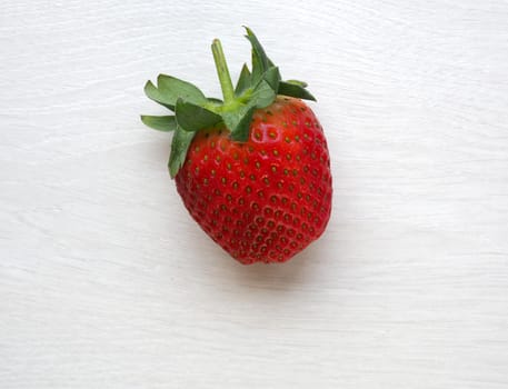 Strawberry on white wood background