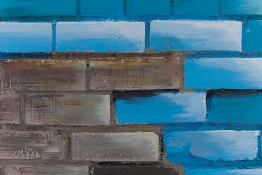 Abstract colorful blue, brown, black and gray painted brick wall as background, texture