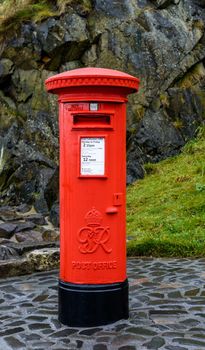 EDINBURGH, SCTOLAND - CIRCA NOVEMBER 2012: Classic red British Post Office mail box operated by Royal Mail.