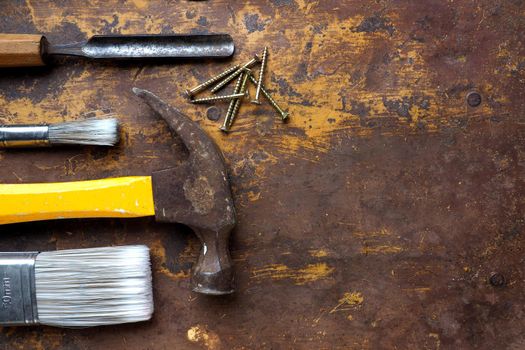 Hammer, chisels and paintbrush, top angle flat lay