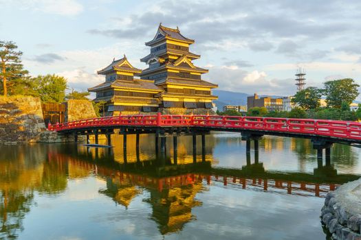 Sunset view of the Matsumoto Castle (or Crow Castle) and bridge, in Matsumoto, Japan