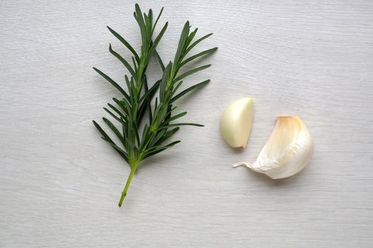 garlic clove and rosemary on white background