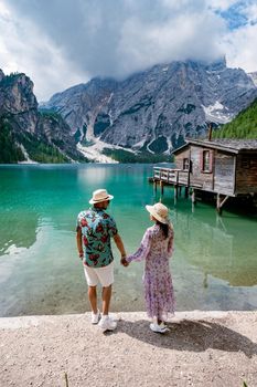 Beautiful lake in the Italian Alps, Lago di Braies in the Italian Dolomites Europe. Braies lake, Italy. The famous lake in the Dolomites, a couple of men and woman mid-age visit Prager wildsee rowing boat