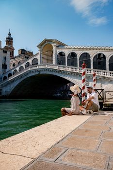 Canals of Venice Italy during summer in Europe,Architecture and landmarks of Venice. Italy Europe, couple men and woman looking at Rialto Bridge Venice