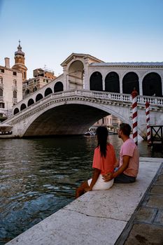 Canals of Venice Italy during summer in Europe,Architecture and landmarks of Venice. Italy Europe, couple men and woman looking at Rialto Bridge Venice