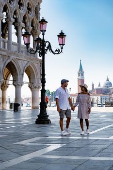 Canals of Venice Italy during summer in Europe,Architecture and landmarks of Venice. Italy Europe , couple men and woman mid age visiting Piazza San Marco
